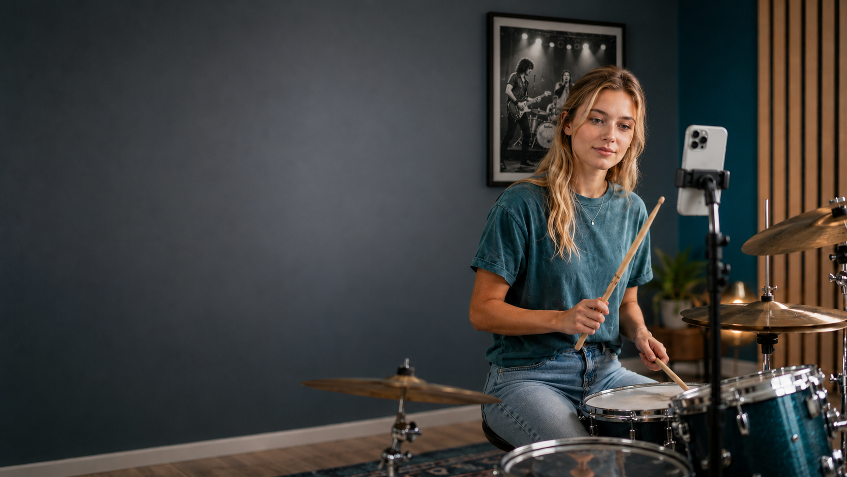 A drummer practicing while recording herself on a phone